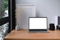 Laptop, books, coffee cup and picture frame on wooden table. Royalty Free Stock Photo