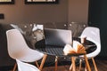 Computer laptop with coffee cup and open book on the black table