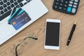 Computer laptop, credit cards, calculater, notbook pen and glasses on the desk, account and saving concept