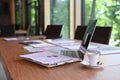 Laptop, documents and coffee cup on wooden table. Royalty Free Stock Photo