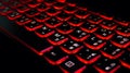 Computer laptop keyboard with red dark backlight, backlit in the dark. Concept computer keyboard background. Royalty Free Stock Photo