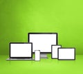 Computer, laptop, mobile phone and digital tablet pc. green background Royalty Free Stock Photo