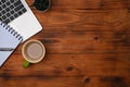 Laptop, notebook and coffee cup on wooden desk. Royalty Free Stock Photo