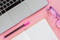 Computer laptop with a pen, an opened notebook and eyeglasses on Royalty Free Stock Photo