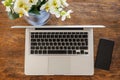 Computer laptop and smartphone on a wood office desk, top view Royalty Free Stock Photo