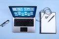 Computer laptop, stethoscope and clipboard