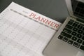 Computer laptop on top of calendar planner