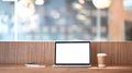 Computer laptop with white blank screen putting on wooden counter bar with takeaway coffee cup and notebook. Royalty Free Stock Photo