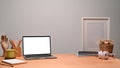 Llaptop with white screen at designer workspace. Royalty Free Stock Photo