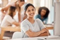 Computer, learning and education with a woman student sitting at a desk in the classroom for study or development Royalty Free Stock Photo