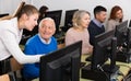 Young woman instructing smiling senior man