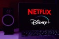 Computer with the logo of: DISNEY PLUS and NETFLIX