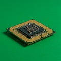 A computer microchip on a green background. This square-shaped chip features a grid Royalty Free Stock Photo