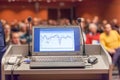 Computer and microphone on rostrum at business event. Royalty Free Stock Photo