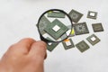 Computer microprocessor that a person views through a magnifying glass Royalty Free Stock Photo