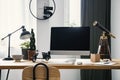 Computer with mockup placed on wooden desk with scooter model, l