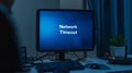 Computer Monitor Displaying Network Timeout Message in Dark Room Royalty Free Stock Photo