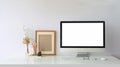 Computer monitor with white blank screen putting on workspace that surrounded by wireless mouse and keyboard. Royalty Free Stock Photo