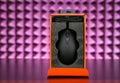 Computer mouse in a box on a table on a pink studio background Royalty Free Stock Photo