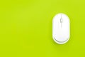 Computer mouse on a green background isolated, flat lay. Royalty Free Stock Photo