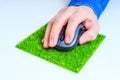 Computer Mouse in Hand on a Grass Mousepad Royalty Free Stock Photo