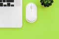 Computer mouse and laptop on a green background isolated, flat lay. Royalty Free Stock Photo