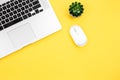 Computer mouse and laptop on a yellow background isolated, flat lay. Royalty Free Stock Photo