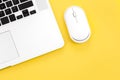 Computer mouse and laptop on a yellow background isolated, flat lay. Royalty Free Stock Photo