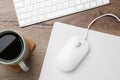 Computer mouse with mousepad, cup of coffee and keyboard on wooden table, flat lay Royalty Free Stock Photo
