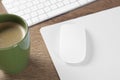 Computer mouse with mousepad, keyboard and cup of coffee on wooden table Royalty Free Stock Photo
