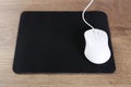 Computer mouse with mousepad on wooden table Royalty Free Stock Photo