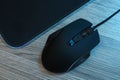 Computer mouse with mousepad on wooden table, flat lay Royalty Free Stock Photo