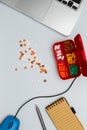 Computer with mouse, daily organizer, pills on white desk Royalty Free Stock Photo