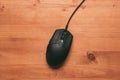 Computer mouse on wooden desk, top view Royalty Free Stock Photo