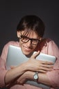 IT computer nerd. Creative teen millenial portrait indoors. Funny young man with happy face expression in glasses hug