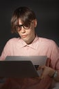 IT computer nerd. Creative teen millenial portrait indoors. Funny young man with happy face expression in glasses hug