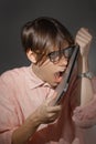 IT computer nerd. Creative teen millenial portrait indoors. Funny young man with happy face expression in glasses hug