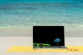 Computer notebook on beach - business travel background Royalty Free Stock Photo