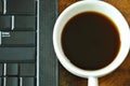 Computer notebook and black coffee cup on table Royalty Free Stock Photo