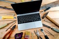 Computer and old tools on a wooden natural background. Royalty Free Stock Photo