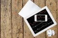 Computer, paper, smartphone and tablet with graph on wood table Royalty Free Stock Photo