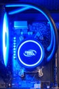 Computer parts inside pc with ice blue led liquid cooling - Moscow, Russia, December 23, 2020