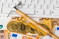 Computer and pickaxe on bitcoins Royalty Free Stock Photo