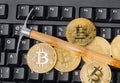 Computer and pickaxe on bitcoins Royalty Free Stock Photo