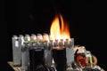 computer power burning, on a black background, close-up, short circuit, electrical equipment ignition Royalty Free Stock Photo