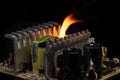 computer power burning, on a black background, close-up, short circuit, electrical equipment ignition Royalty Free Stock Photo
