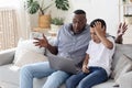Computer Problem. Shocked Black Boy And His Grandfather Looking At Laptop Screen Royalty Free Stock Photo