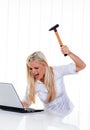 Computer problems with a hammer and a laptop Royalty Free Stock Photo