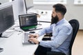 Computer programmer developer working in IT office, sitting at desk and coding, working on a project in software Royalty Free Stock Photo