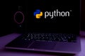 Computer with the Python logo is an interpreted programming language whose philosophy